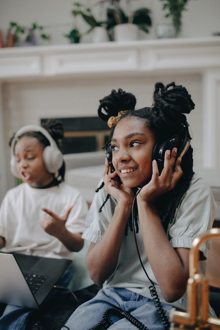 A Young Girl Listening To Music While Wearing Headset