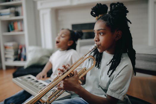 Girl playing trumpet with sibling at home, enjoying music time.