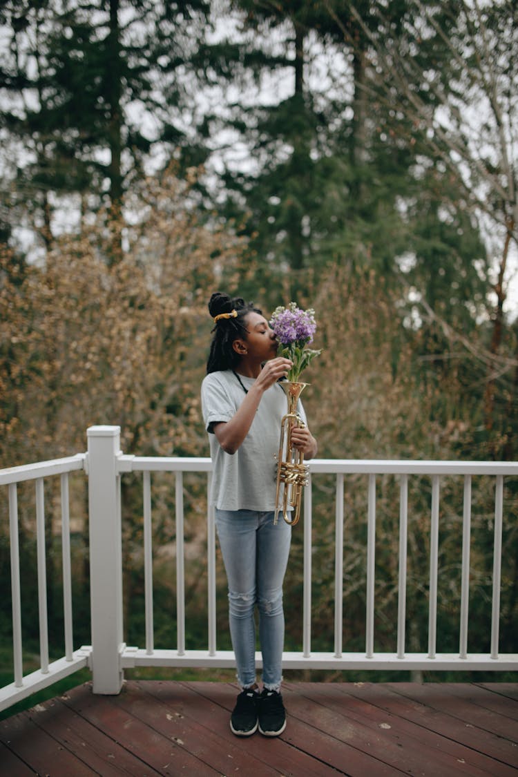 A Girl Smelling The Flower