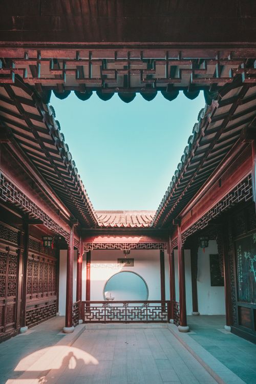 Free Explore the beauty of traditional Chinese architecture in this serene courtyard with a clear blue sky above. Stock Photo