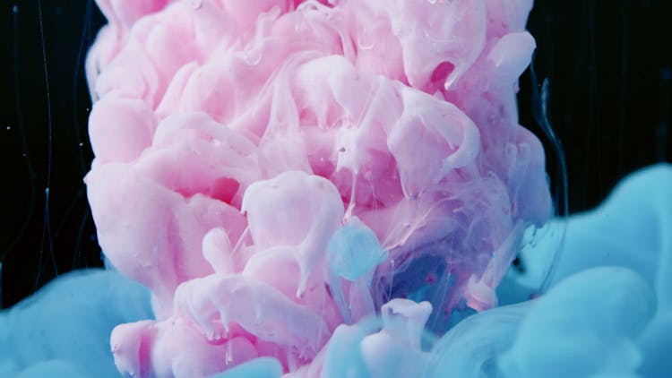 Pink And Blue Paint Mixed In Water