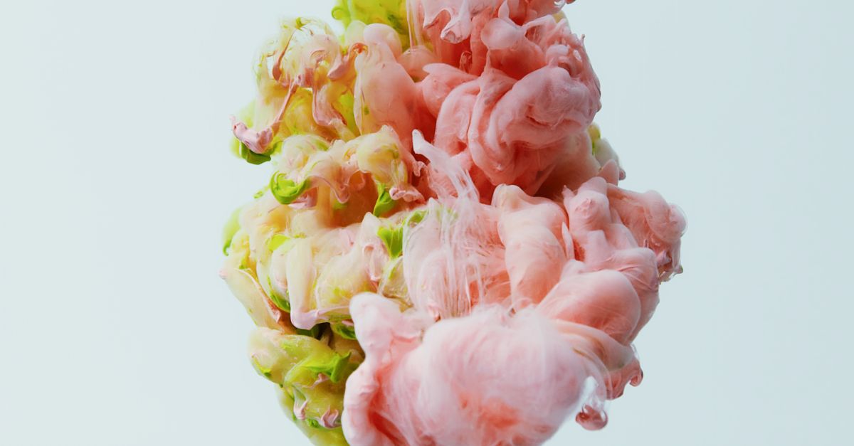 Fluffy pastel cloud bread being squished in slow motion with colorful background
