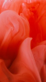Vibrant close-up of red liquid swirling, showcasing modern abstract art style and texture.