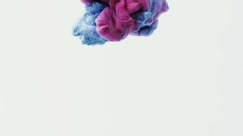 Free Colorful abstract image of pink and blue paint swirling in water. Stock Photo