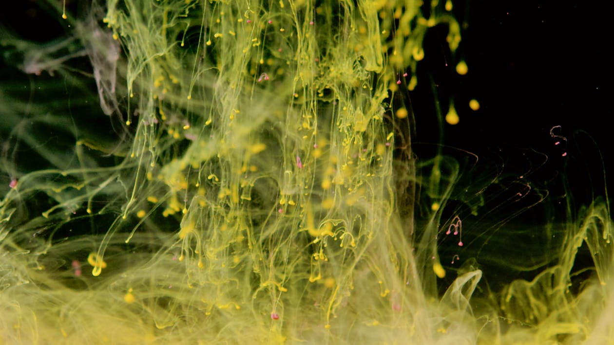 Yellow Ink in Black Water Free Stock Photo