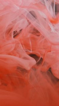 Vivid and dynamic swirls of red smoke captured in an abstract and artistic style.