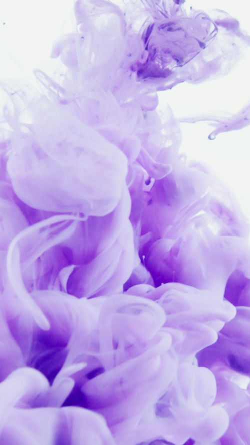 Free Abstract violet ink swirling in water creates a dreamy, artistic flow. Stock Photo