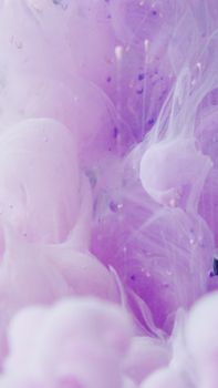 Abstract image showcasing ethereal purple ink swirls floating in water.
