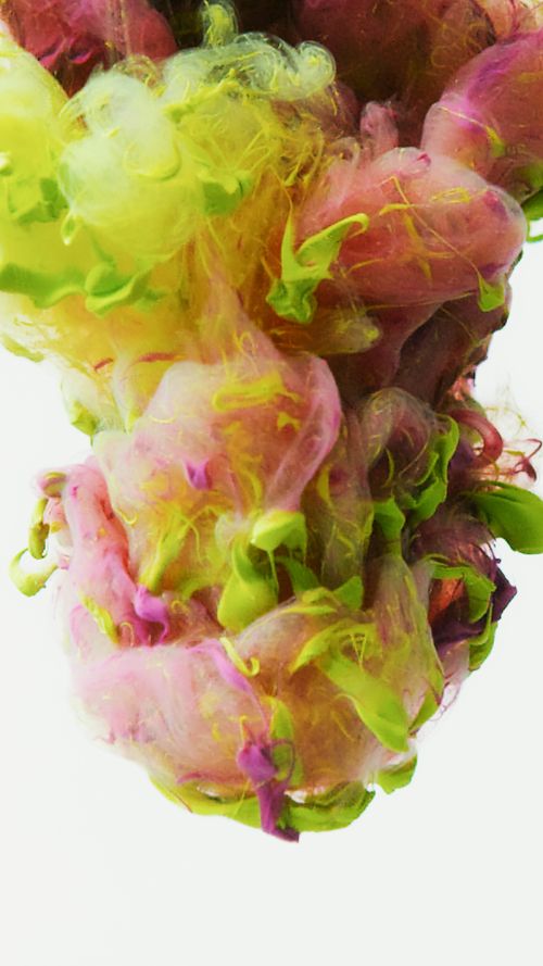 Free Colorful abstract image of paint swirling in water, creating a vibrant splash effect. Stock Photo
