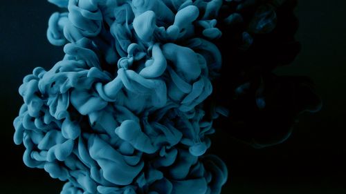 Free Abstract blue ink cloud in water forming intricate patterns on a black background. Stock Photo