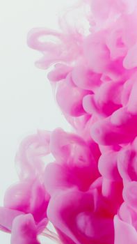 Abstract composition of swirling pink acrylic paint creating a dynamic and vibrant texture.