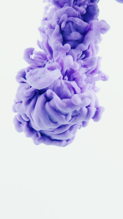 Free Dynamic vibrant purple ink splash captured in motion against a clean white background, creating a sense of fluidity. Stock Photo