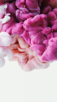 Abstract pink and white ink swirling in water, creating a fluid and dynamic composition.