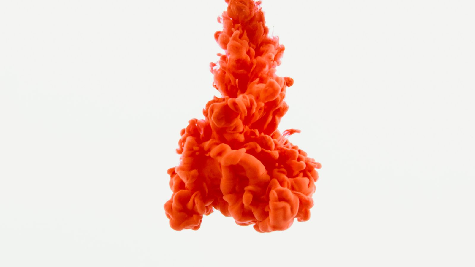 Orange ink cloud against a white background