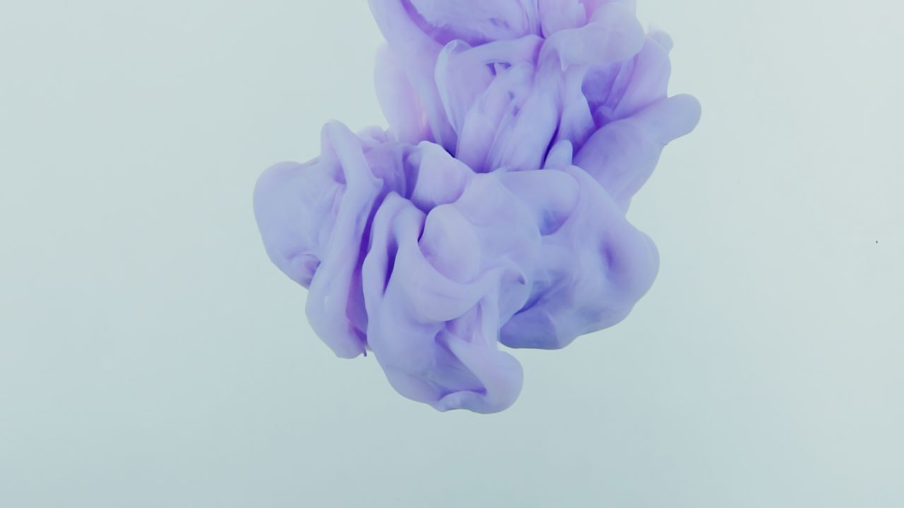 soft purple ink swirling gracefully in clear water creating an abstrac