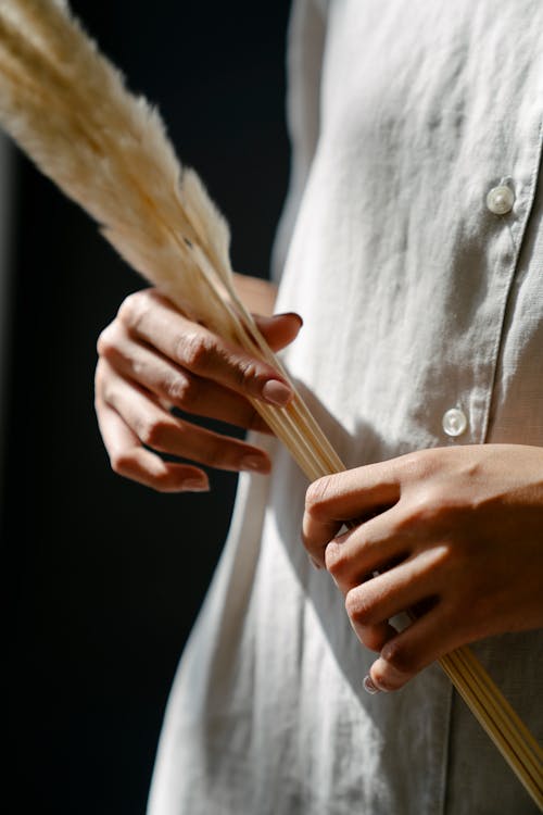 Woman holding long feather in hands