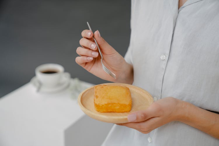 Anonymous Woman With Sponge Cake On Plate