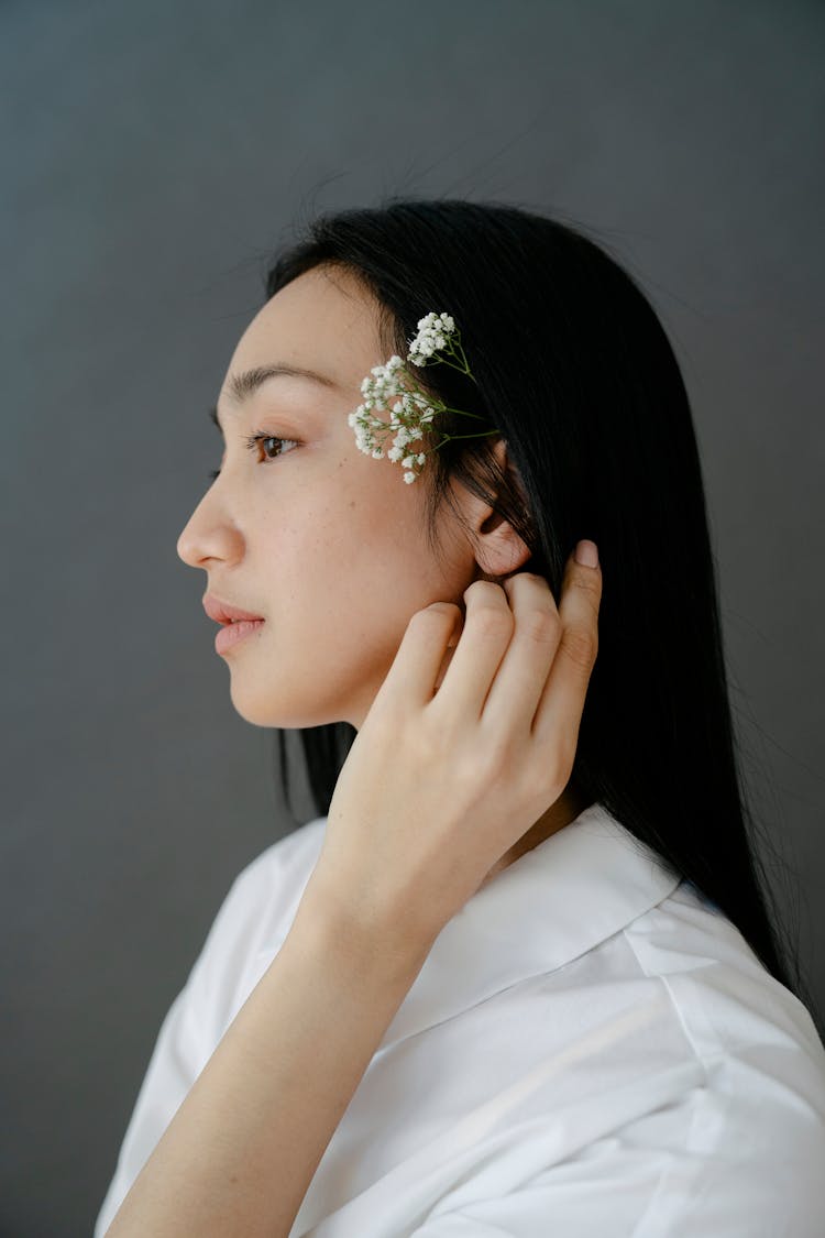 Charming Asian Woman With Twig In Hair