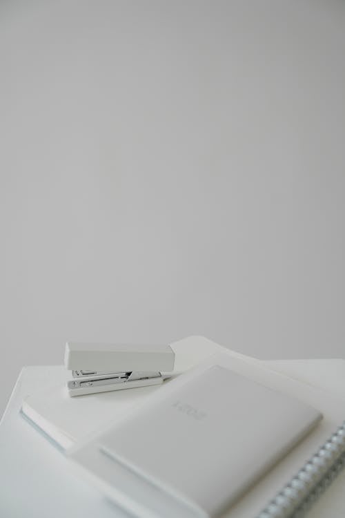 Table with notebooks and stapler