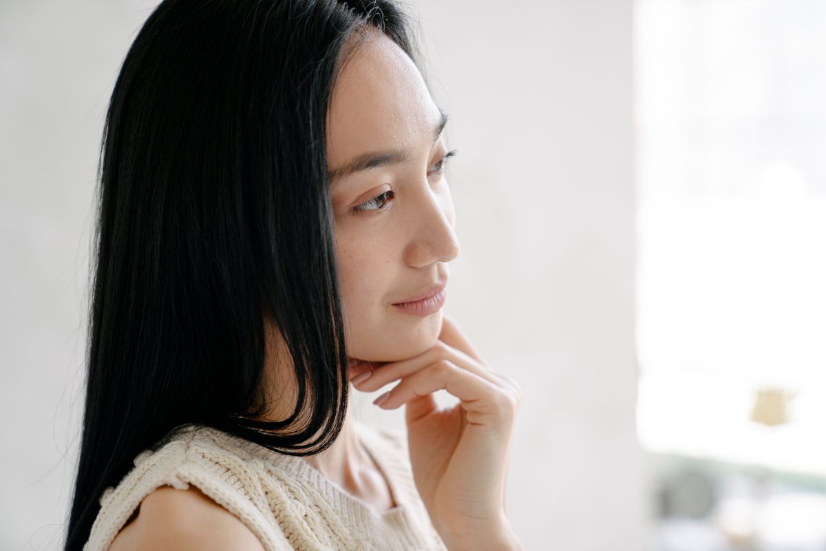 Real woman in side profile showing facial areas including cheek jawline and under-chin