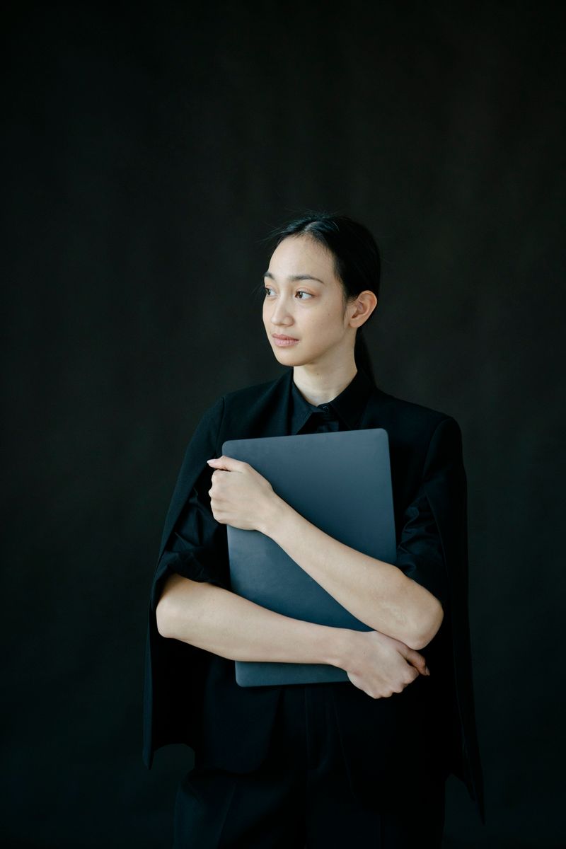 Portrait of an architect and interior designer against a warm neutral background
