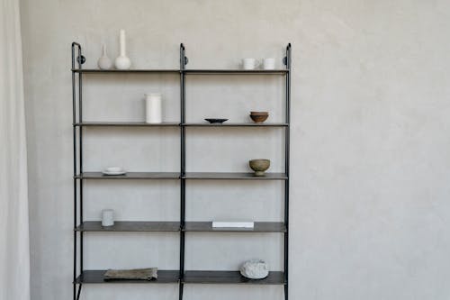 Black Wall-Mounted Bookcase with Decorations