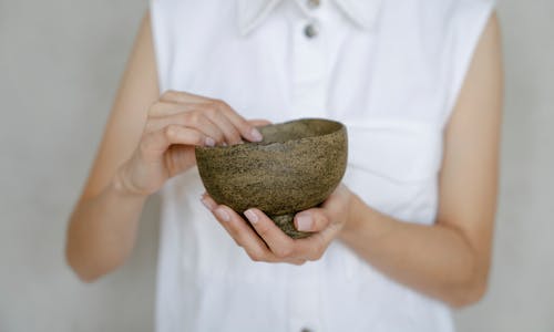 Close-up of a Woman Holding an Uneven Ceramic Bowl 