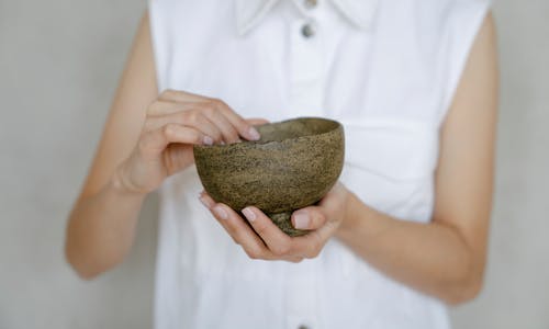 Close-up of a Woman Holding an Uneven Ceramic Bowl 