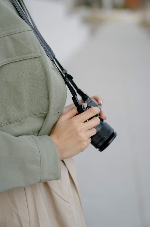 Free Detailed view of hands holding a camera outside, emphasizing photography hobby. Stock Photo