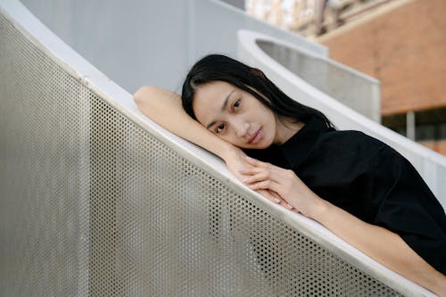 Woman Leaning on Railing