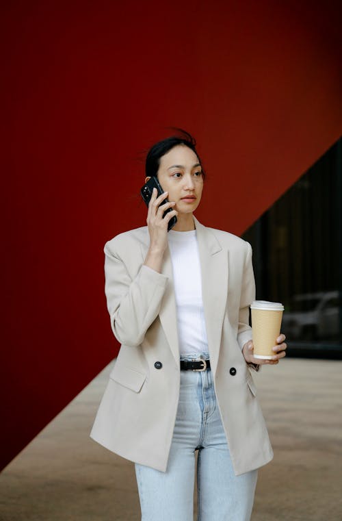 Asian woman talking on smartphone in city