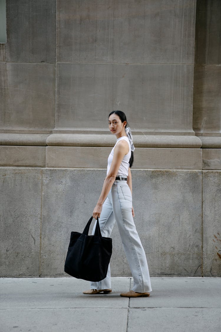 Trendy Ethnic Woman With Textile Bag In Street