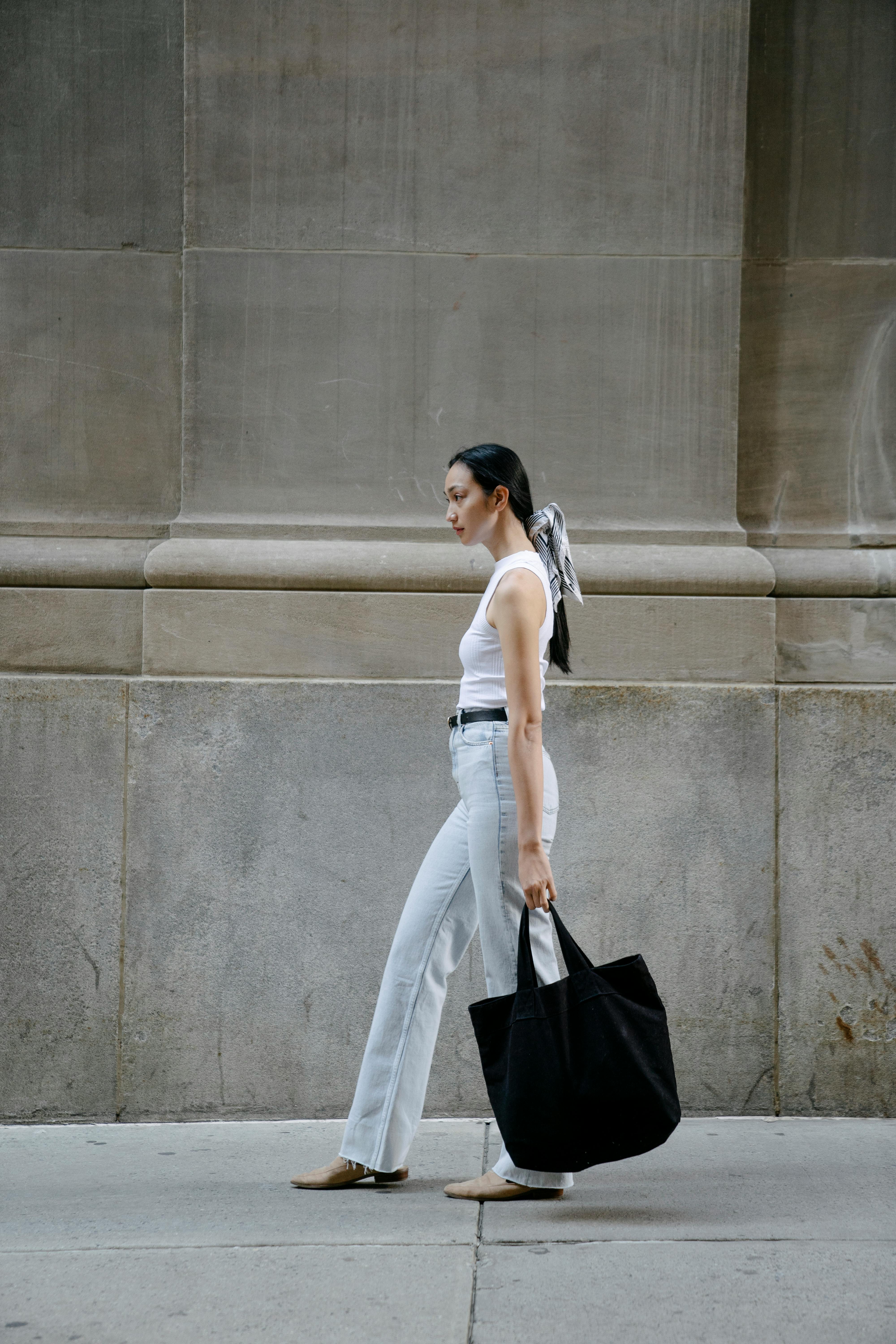 asian woman with eco friendly bag in city