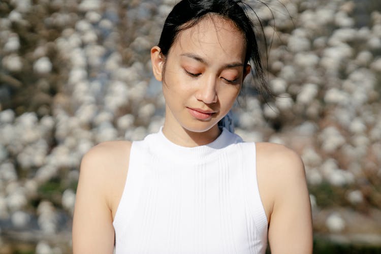 Tender Ethnic Woman In Windy Weather On Sunny Day