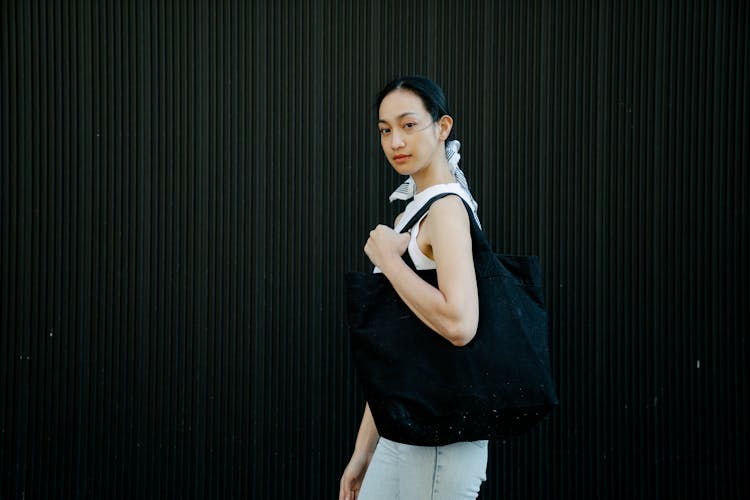 Trendy Ethnic Woman With Textile Bag On Street