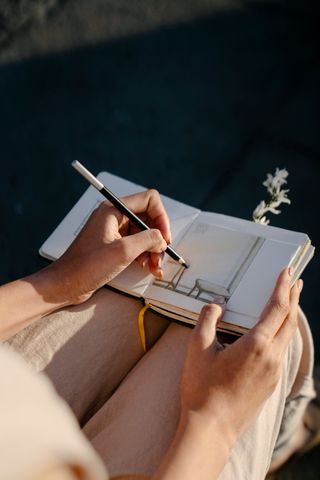 Designer sketching in a notebook — photo by John Diez on Pexels