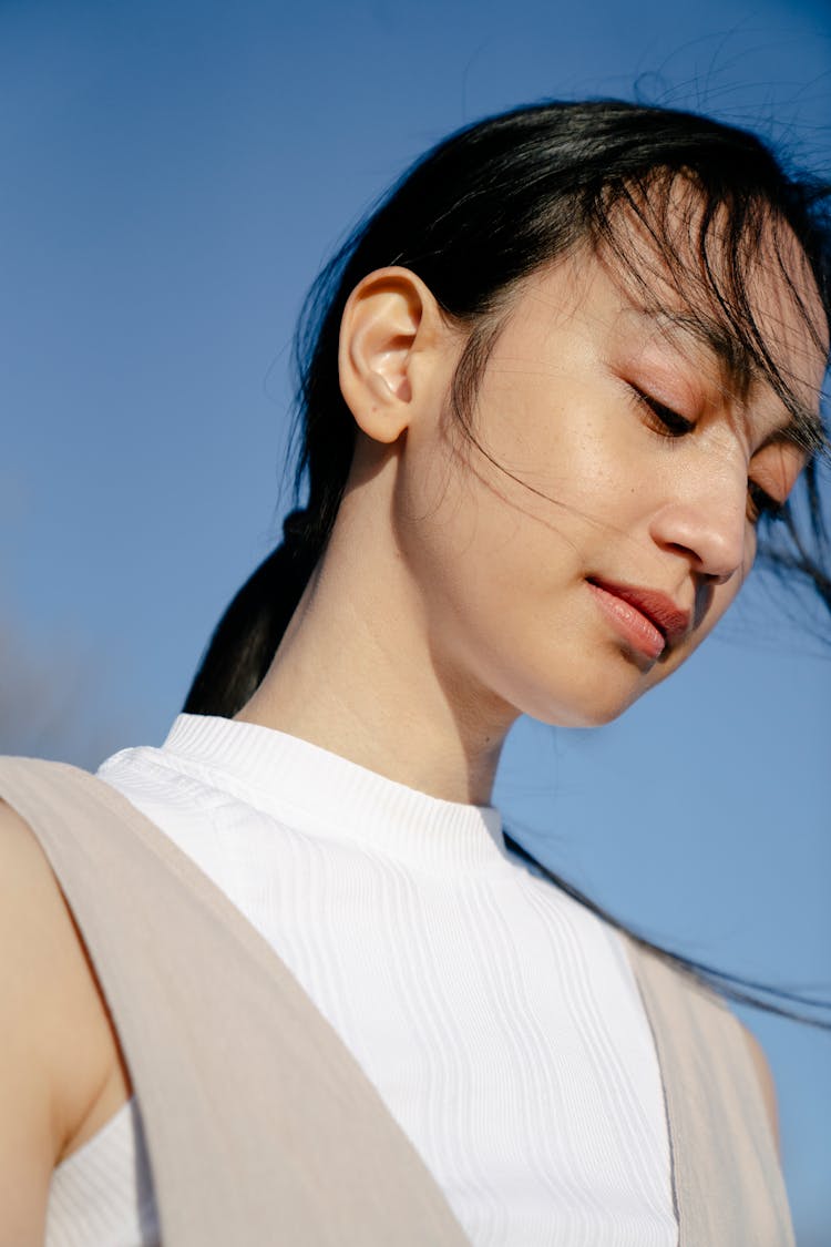 Charming Asian Woman Under Blue Sky In Sunshine