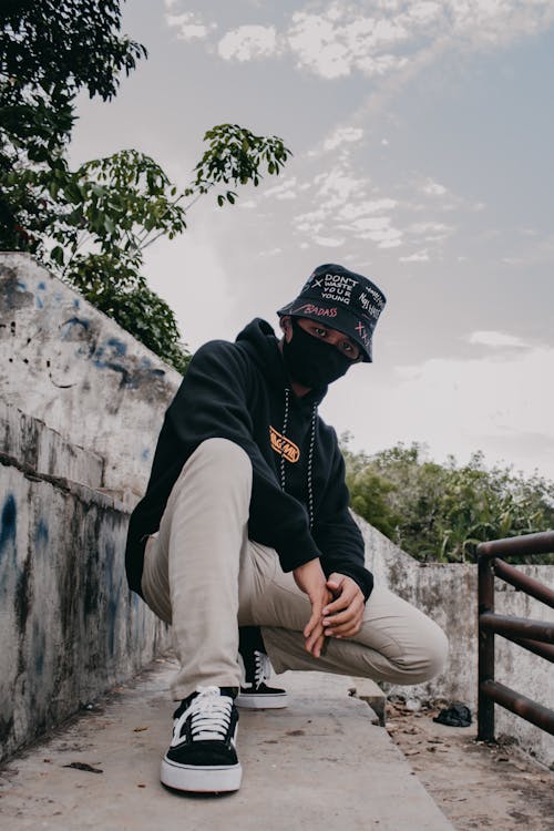 Man with a Bucket Hat Posing while Crouching