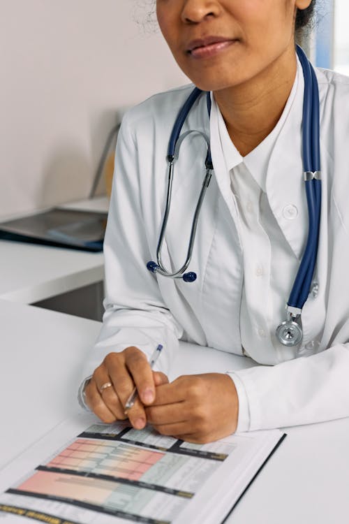 Person in White Suit with Blue Stethoscope