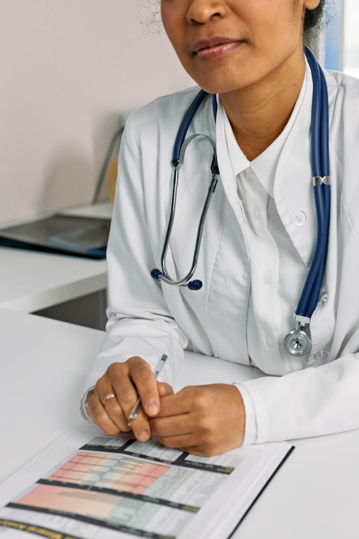 Older woman at a medical clinic discussing vaccination with a nurse