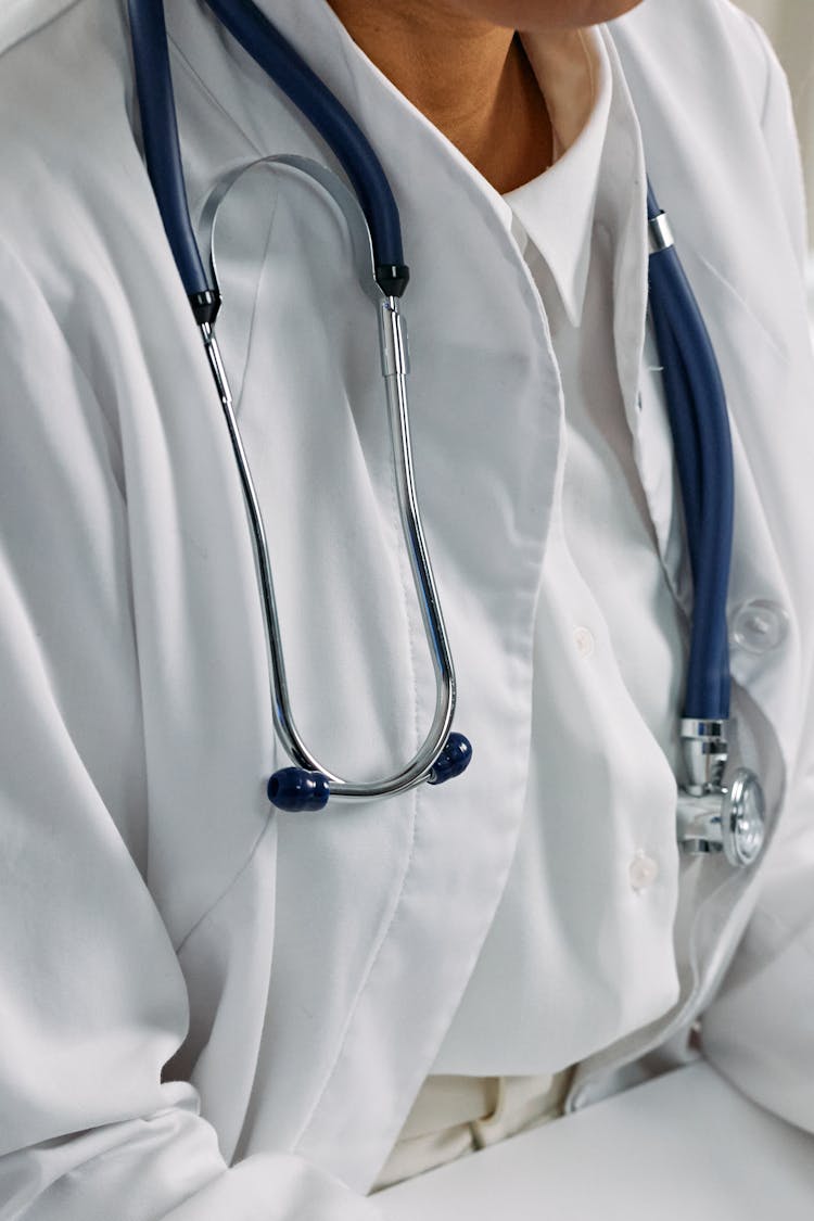 Blue And Silver Stethoscope On White Textile