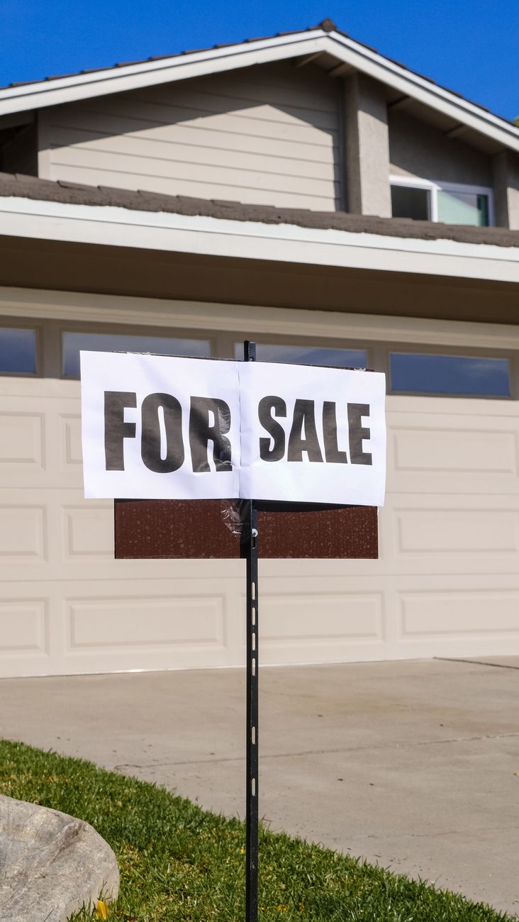 A suburban home listed for sale, illustrating the slow turnover that still shapes demand for large renovation projects.