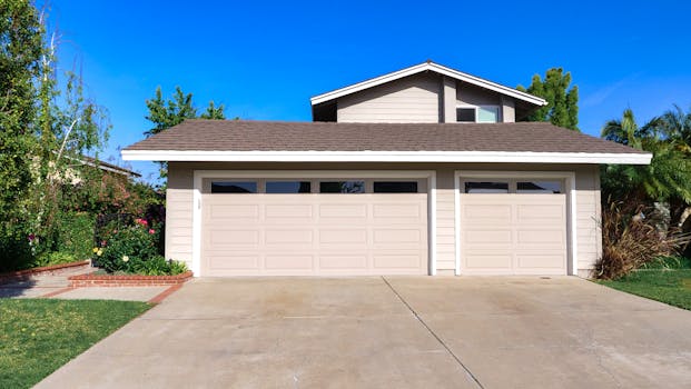 Exterior view of a cozy suburban house with a double garage, perfect for families.