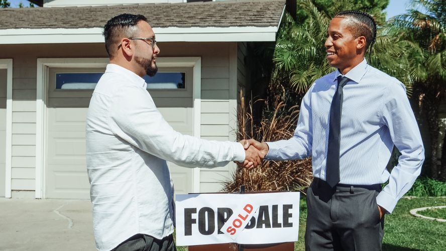 Real estate agent and clients discussing offer strategy