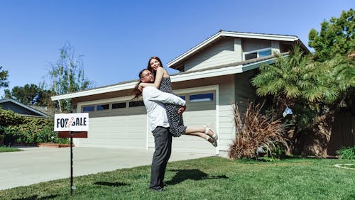 Free Man and Woman In Front of their House Stock Photo