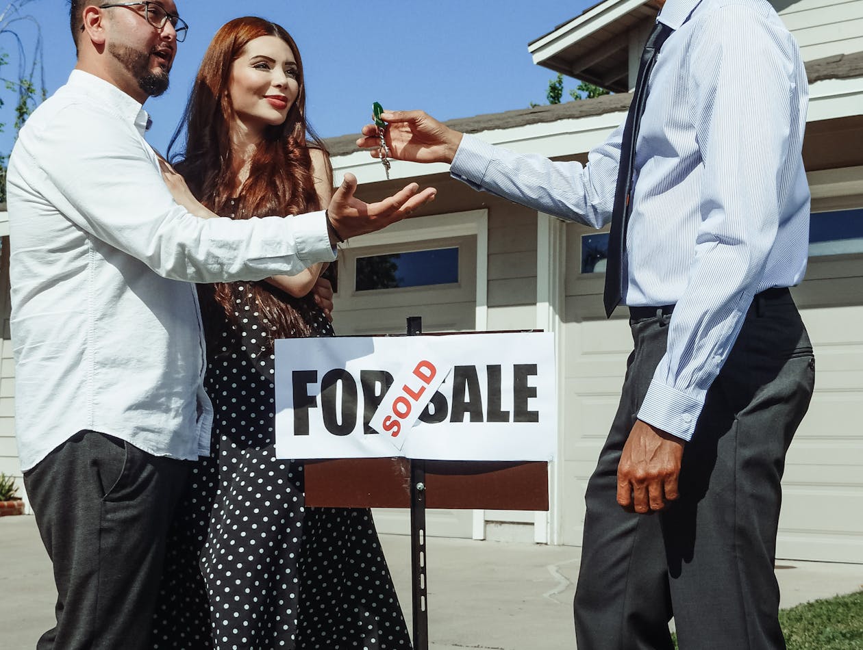 Young couple receiving keys to their first home in the Antelope Valley — Palmdale and Lancaster first-time buyers
