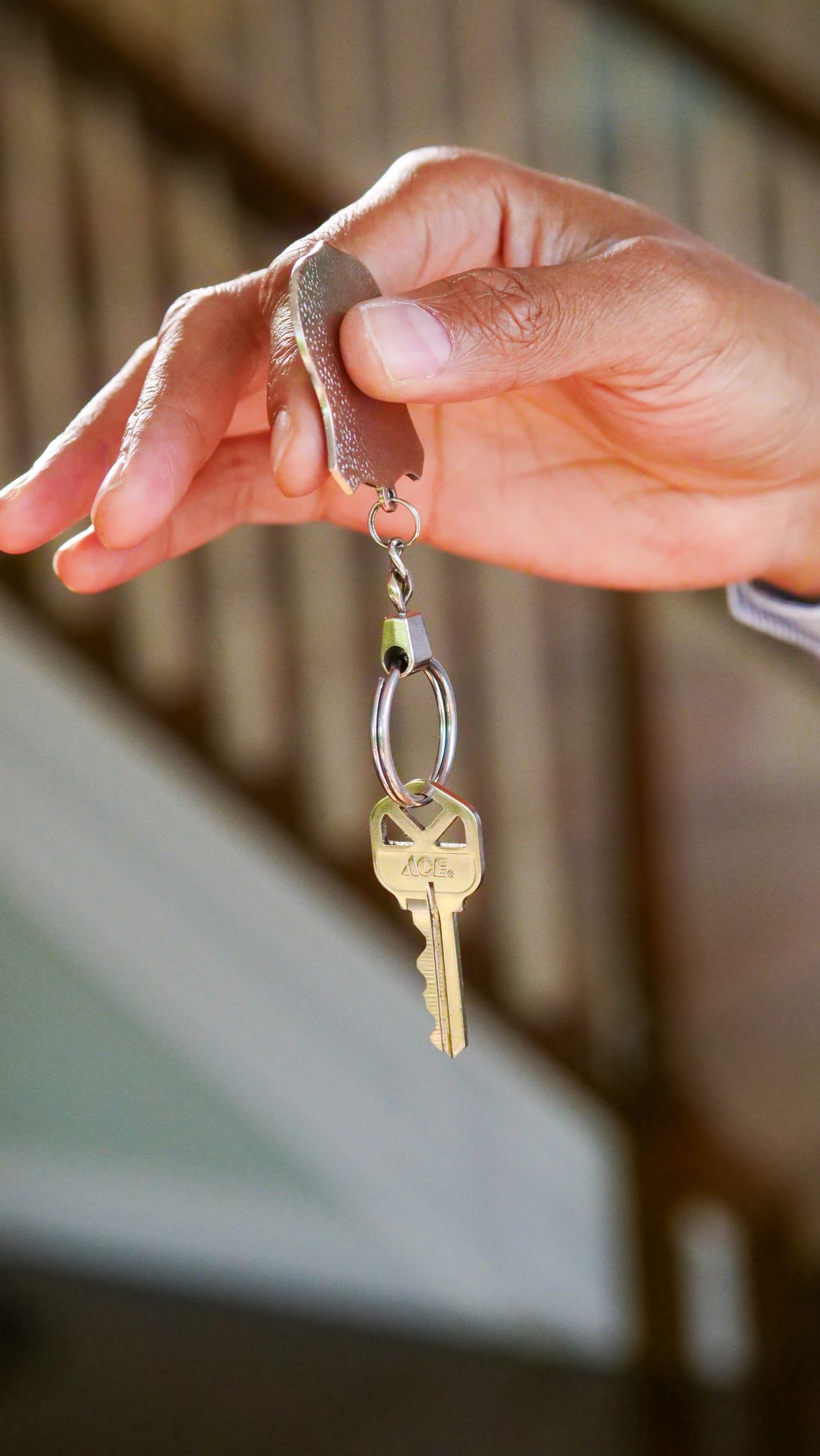 Person Holding a Keychain with Key · Free Stock Photo