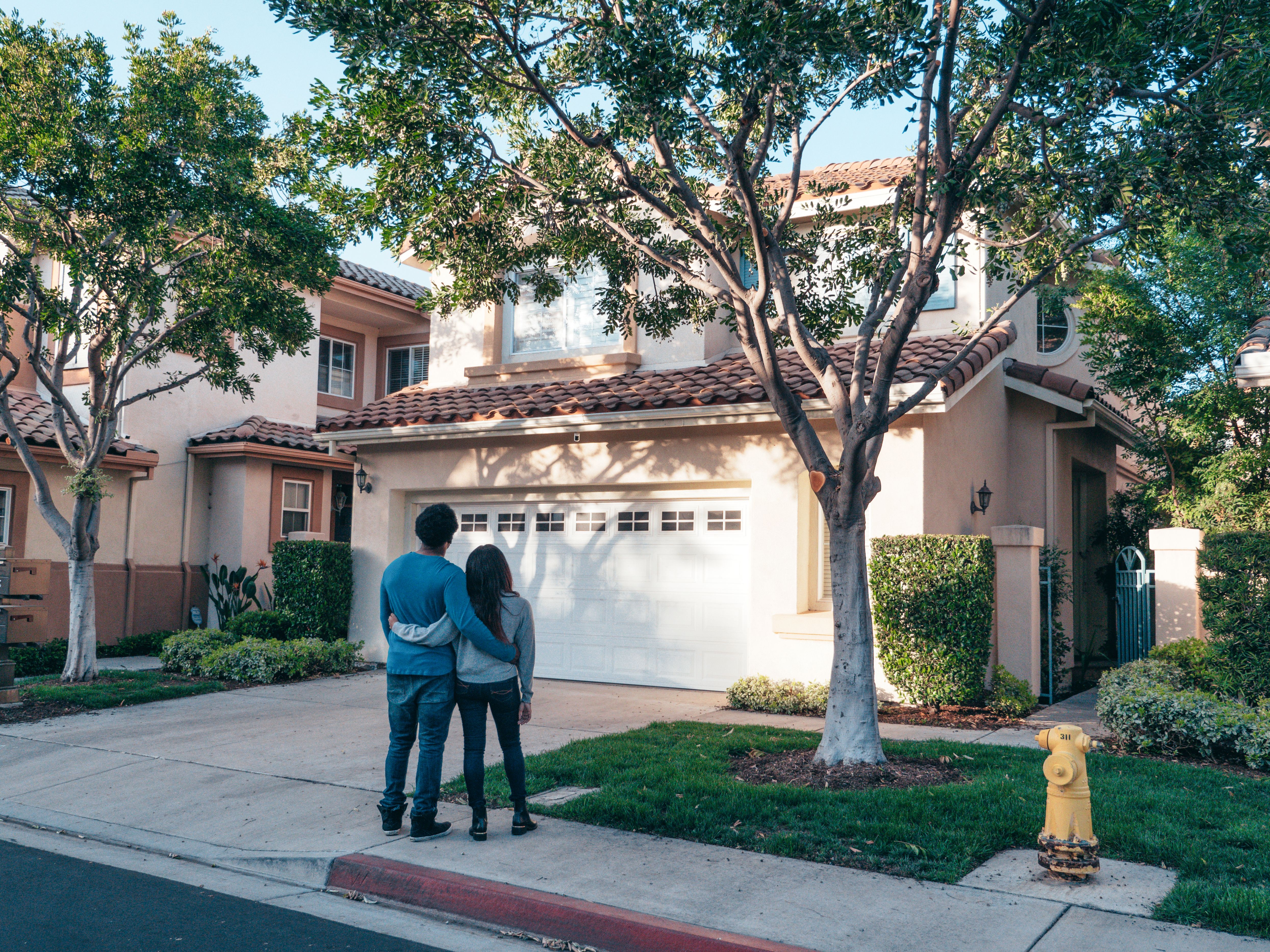 family standing outside a newly purchased home
