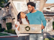 Man in Blue Crew Neck Long Sleeve Shirt Holding Brown Wooden Home Decoration