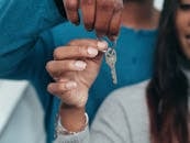 People Holding a Key